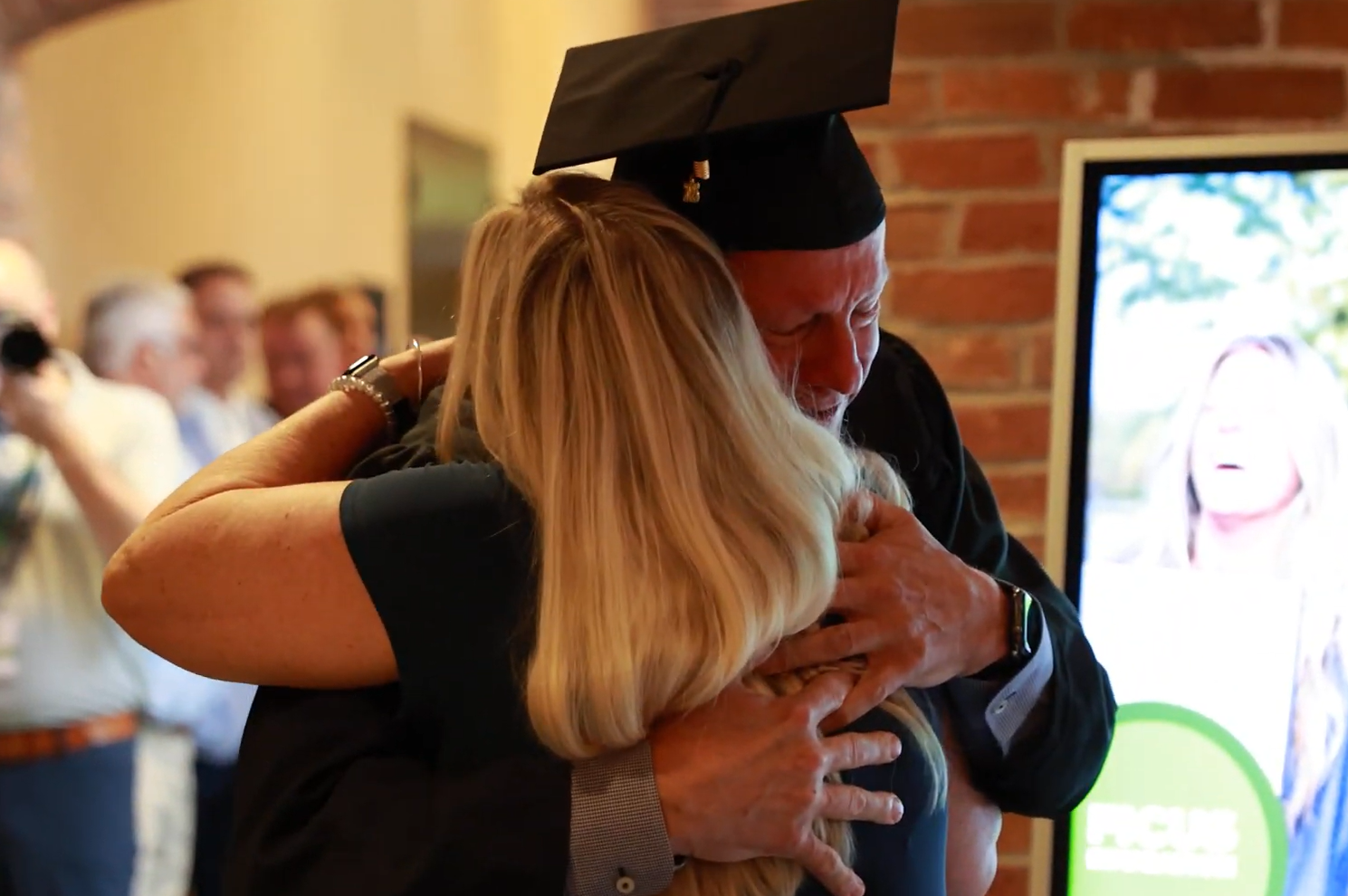 Graduate with Loved One, © Ficus Education, 2025