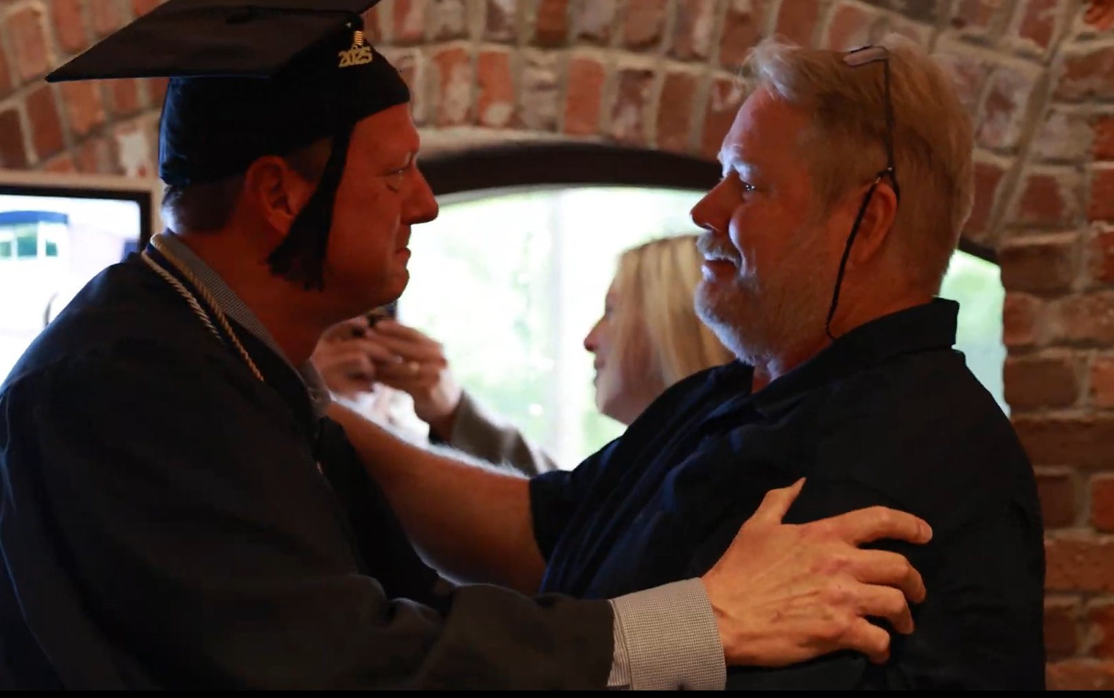 Graduate with Loved One, © Ficus Education, 2025