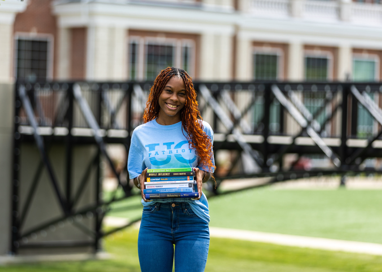 Student Holding Free Textbooks Student Holding Free Textbooks