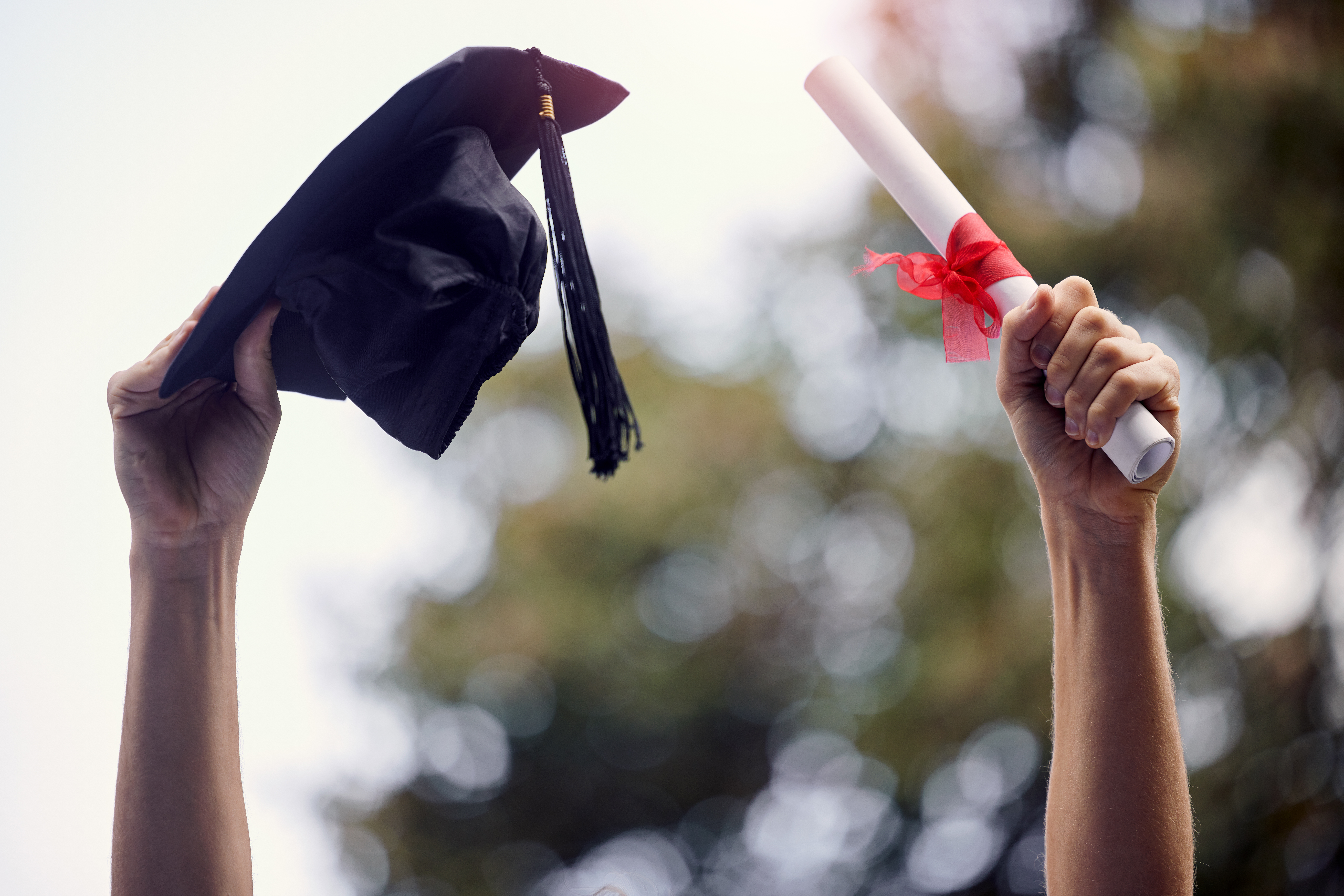 my-limit-is-beyond-sky-closeup-shot-unrecognisable-graduate-holding-their-cap-diploma-graduation-day